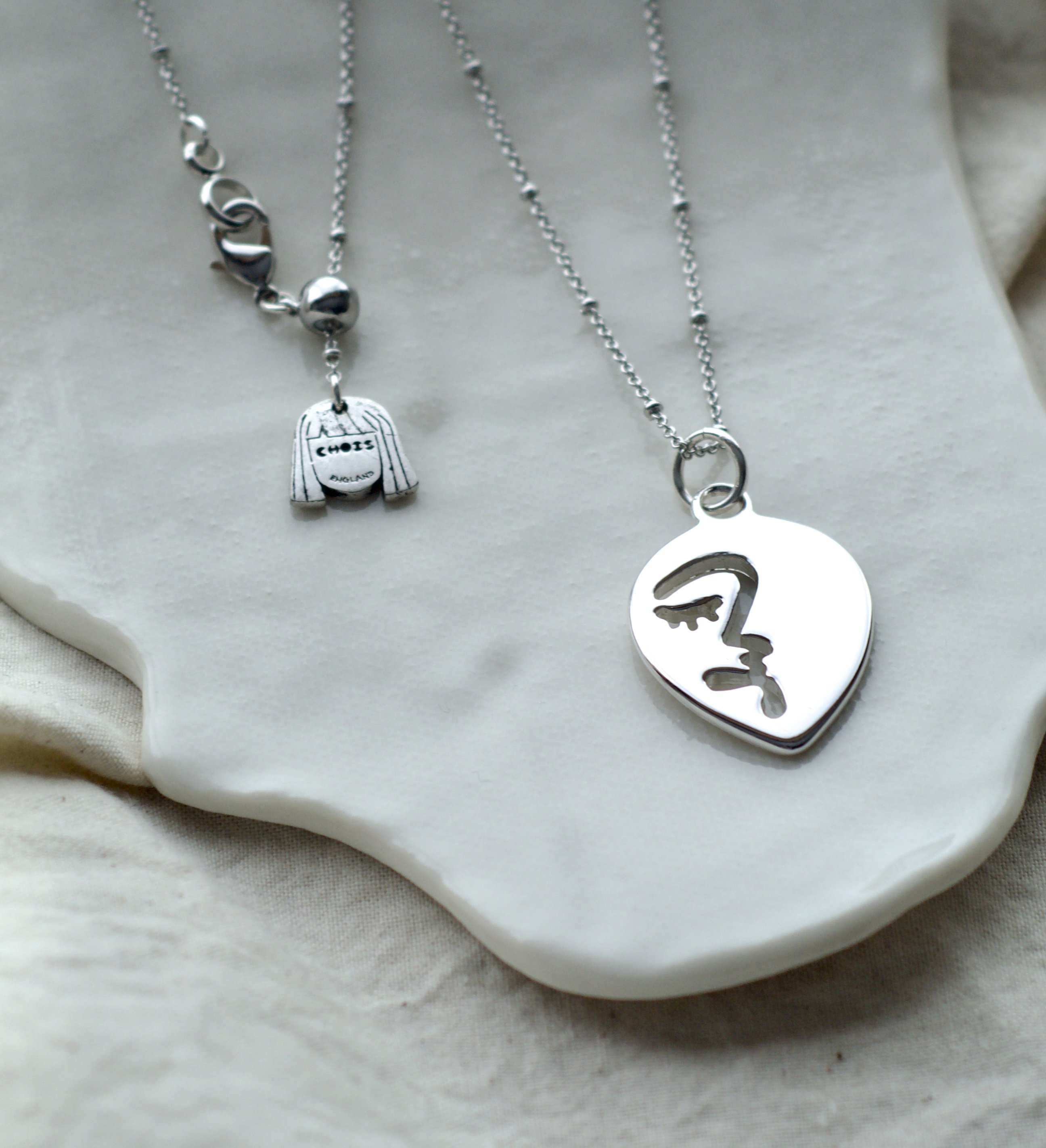 Abstract Face Pendant In White Gold Tone